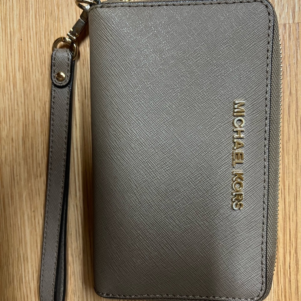 Michael Kors wristlet wallet taupe color good used condition. Gold slightly worn